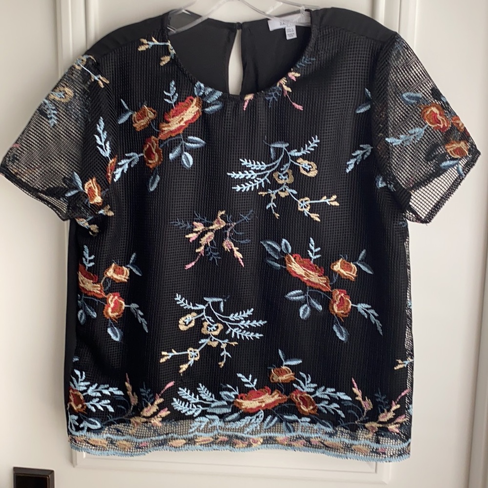 Black short sleeve top. Cool and casual to dressy.
